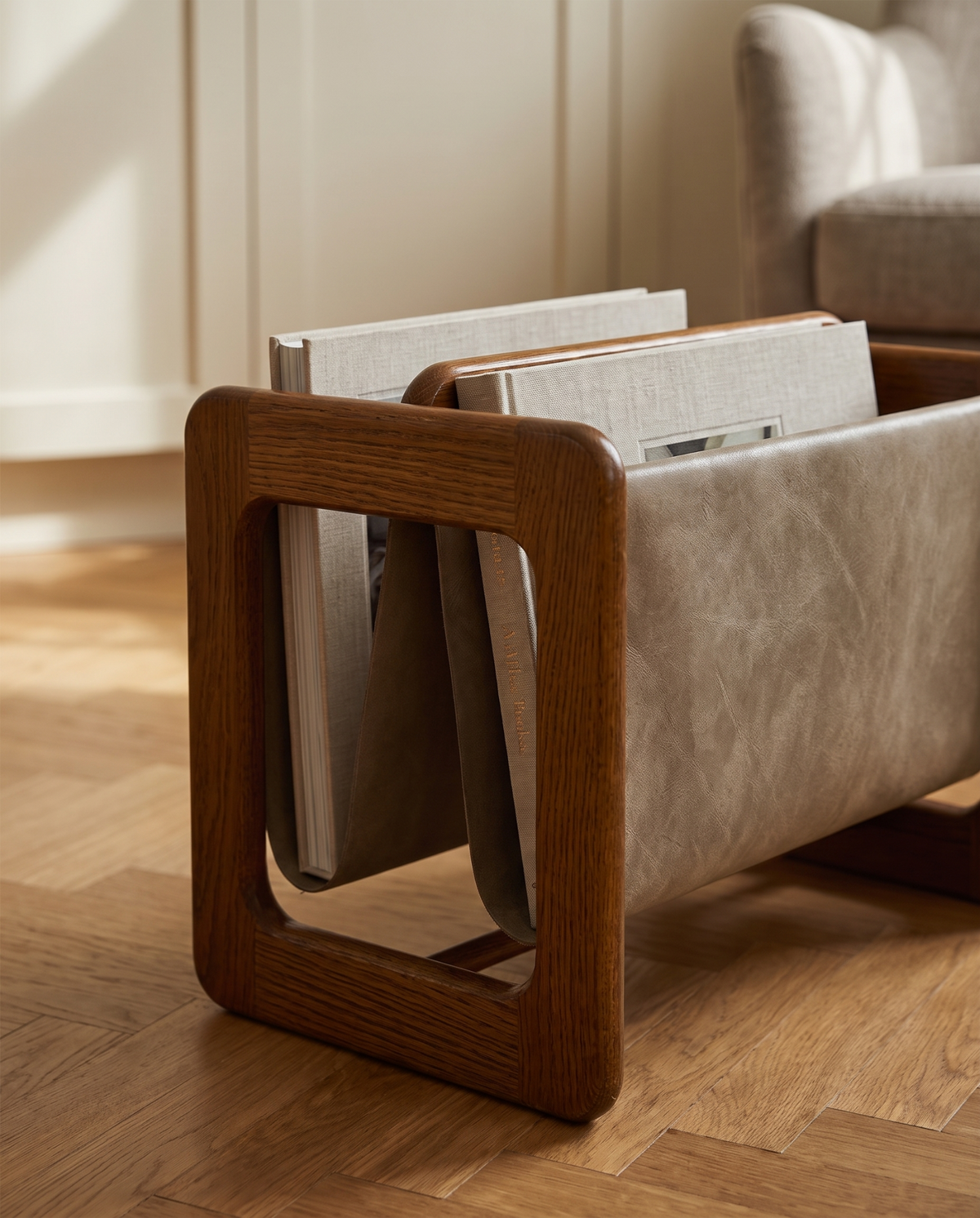 Danish oak and leather magazine stand in interior setting