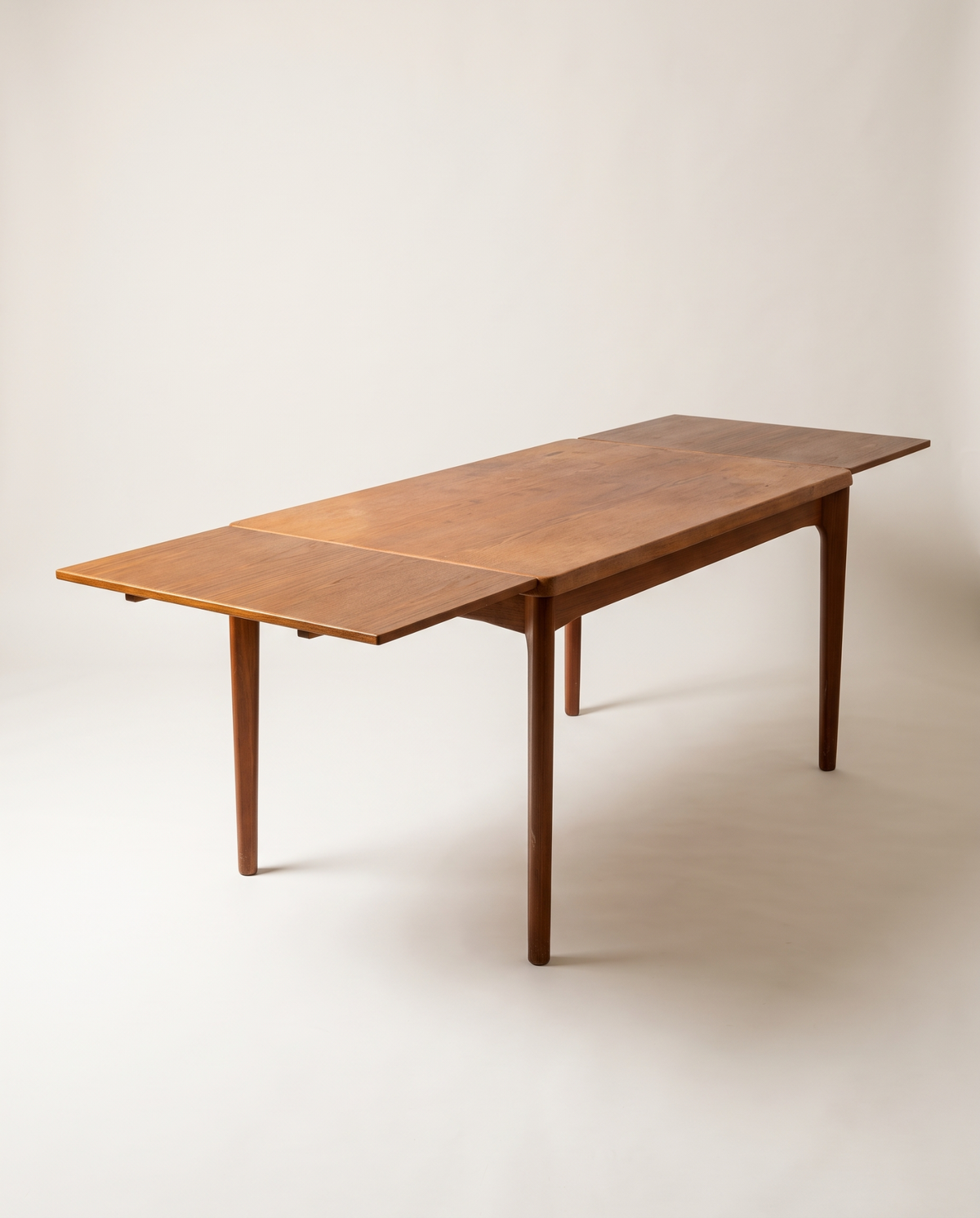 Teak extending dining table attributed to Henning Kjærnulf for Vejle Møbelfabrik