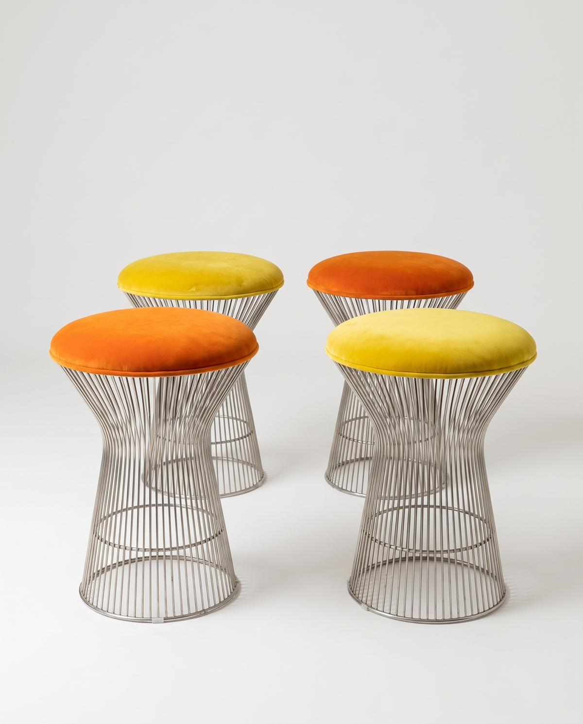 Set of four vintage chrome wire stools with orange and yellow seats