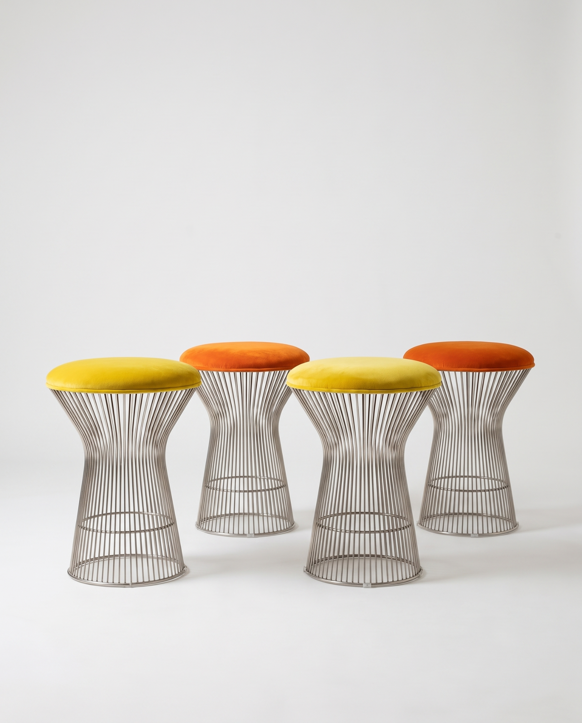 Four vintage hourglass stools with chrome wire frames